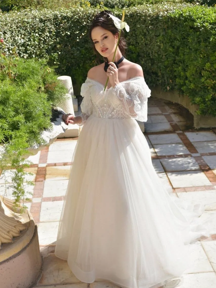 Full-length ivory lace gown on the garden terrace